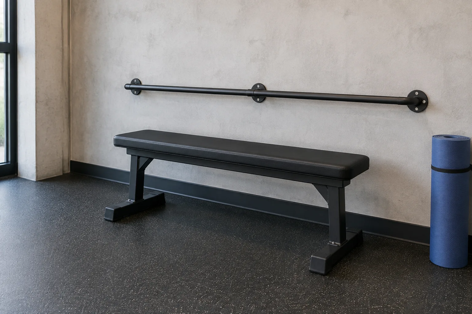 An empty padded exercise bench, a stable support rail, and clear floor space