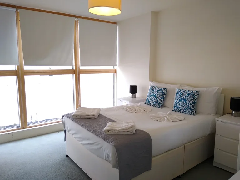 A quiet bedroom with a made bed