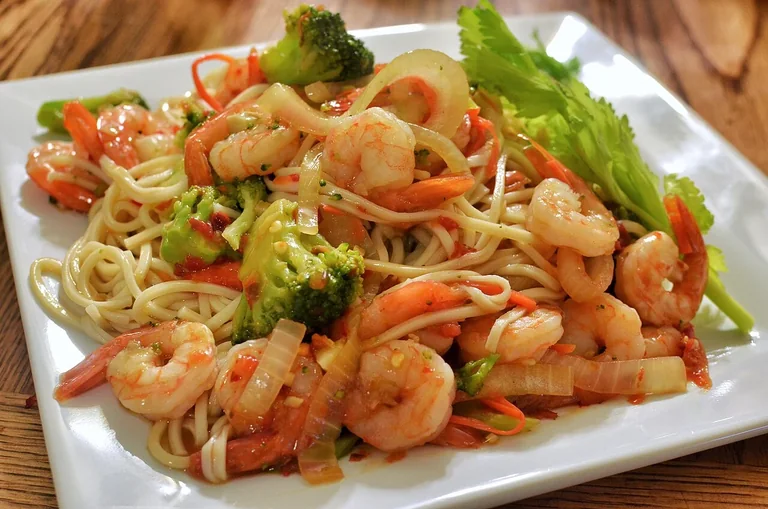 Shrimp and broccoli stir fry served with noodles