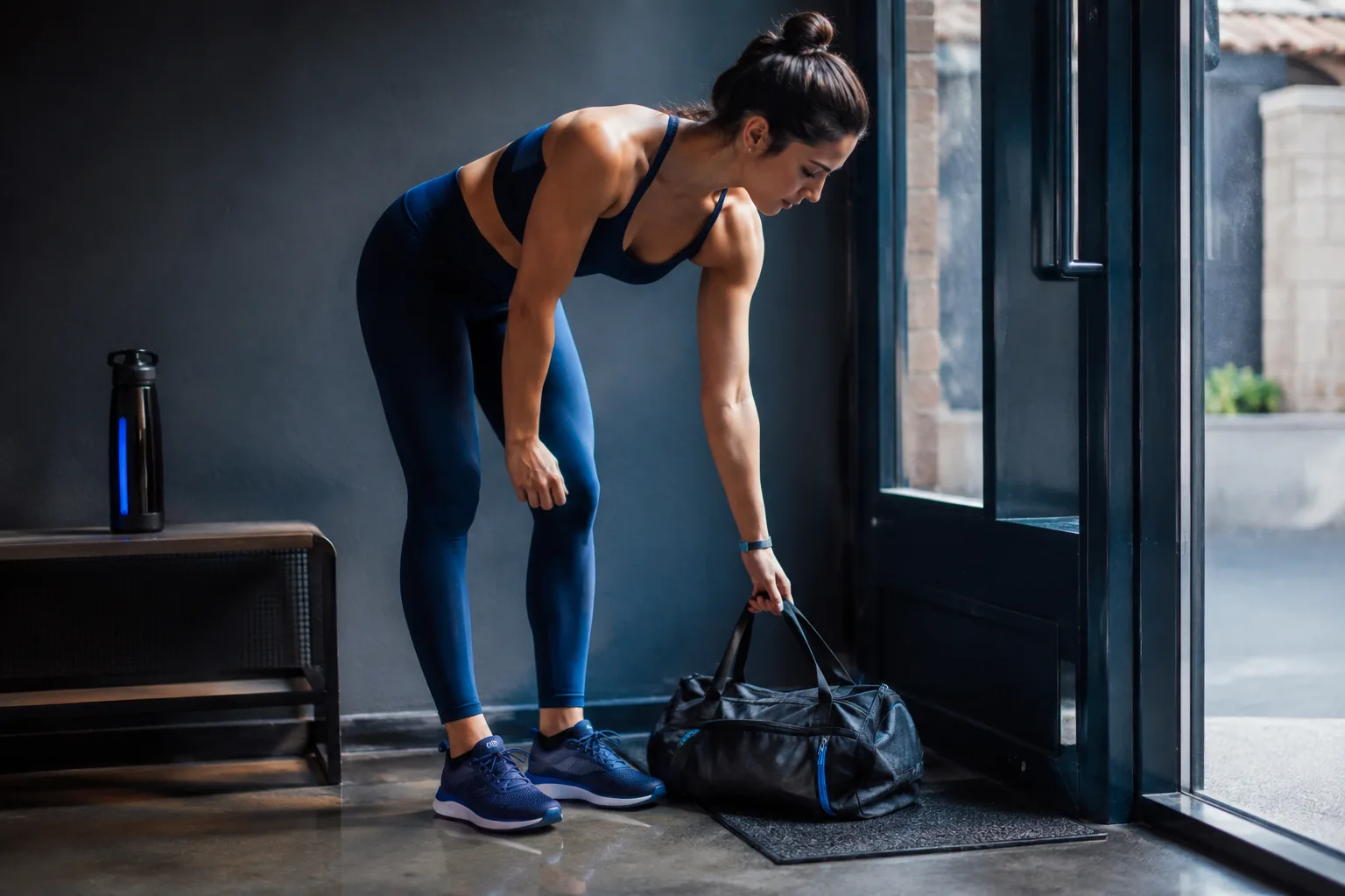 A person preparing a gym bag for the next session